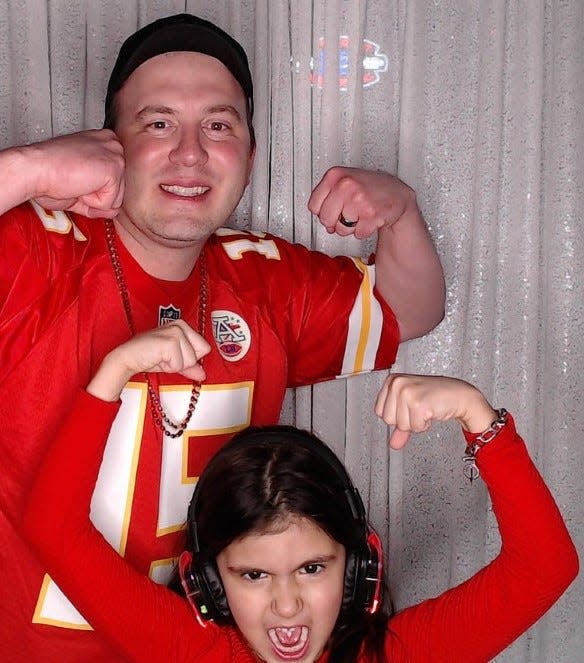 Kansas City Chiefs fans Josh Kingsley and his daughter, Vivian, took pictures in a photo booth during a previous Super Bowl party at Buffalo Wild Wings in Brookfield.