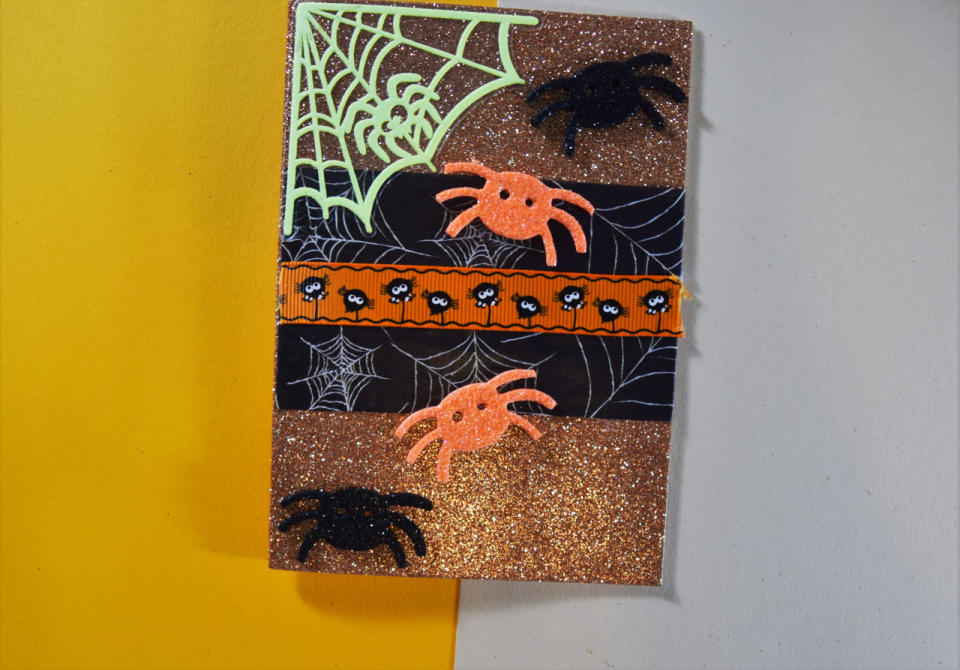  Finally, place your glitter spider foam stickers where you want them and you’re ready to write your message in the inside. Go forth, eat Halloween candy and craft!