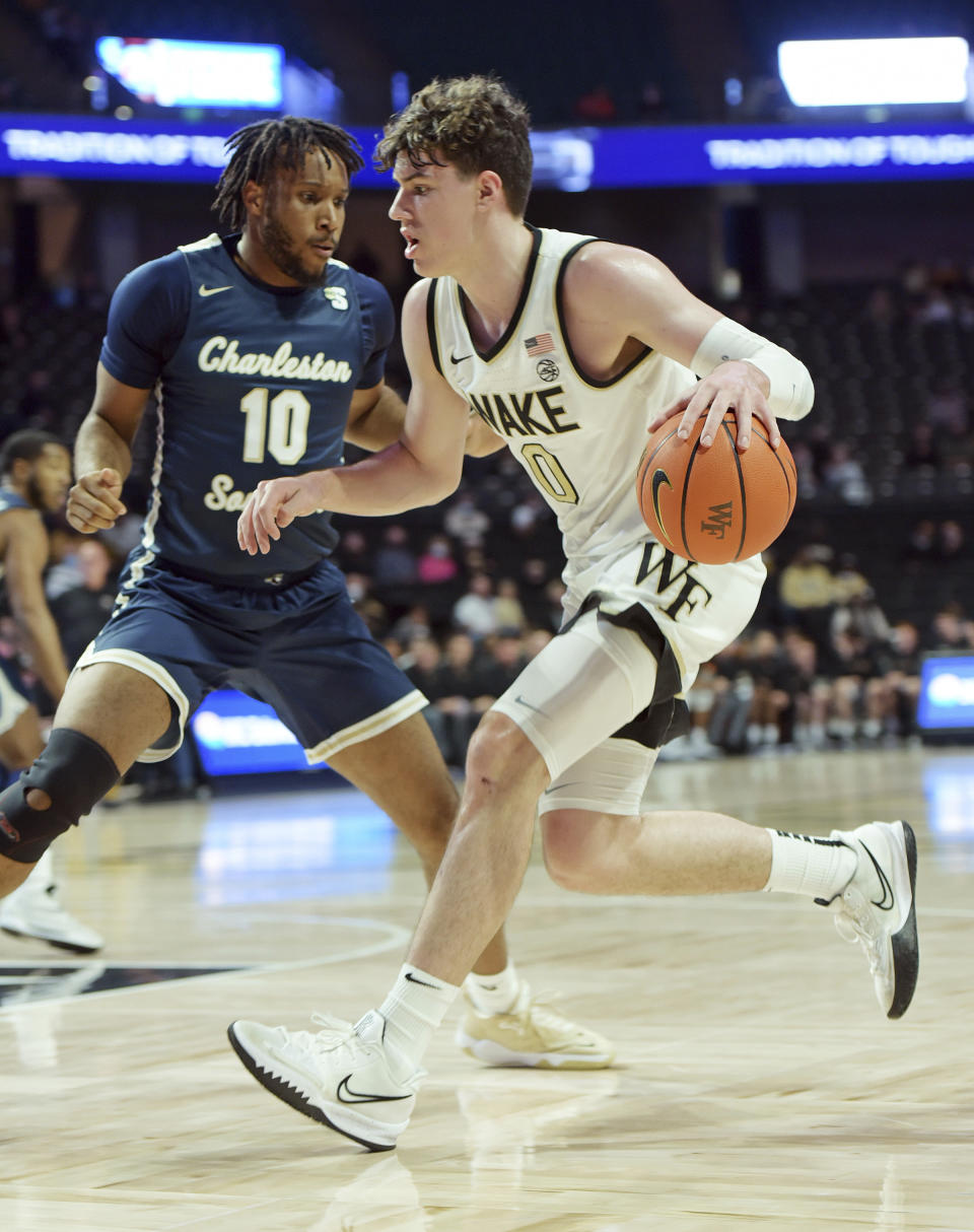 Wake Forest's Jake LaRavia drives to the basket under pressure from Charleston Southern's Jamir Moore during the first half of an NCAA college basketball game Wednesday, Nov. 17, 2021, in Winston-Salem, N.C. (Walt Unks/The Winston-Salem Journal via AP)