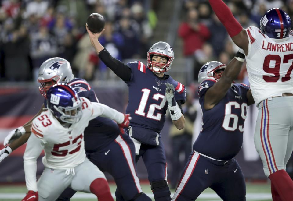 New England Patriots quarterback Tom Brady passes under pressure from the New York Giants in the first half of an NFL football game, Thursday, Oct. 10, 2019, in Foxborough, Mass. (AP Photo/Charles Krupa)