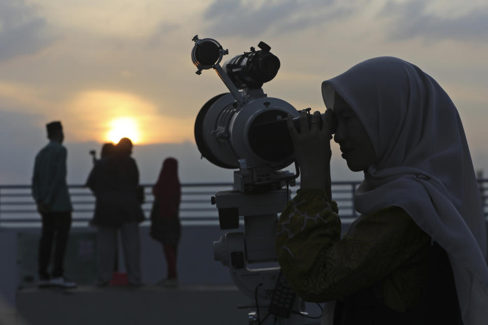 A member of staff uses a telescope to search the sky for the new moon that signals the start of the Islamic holy fasting month of Ramadan, at the Astronomical Observatory of the Muhammadiyah University of North Sumatra in Medan, Indonesia, Sunday, March 10, 2024. People in the world's most populous Muslim country will start observing Ramadan, the holiest month in Islamic calendar on March 12. (AP Photo/Binsar Bakkara)