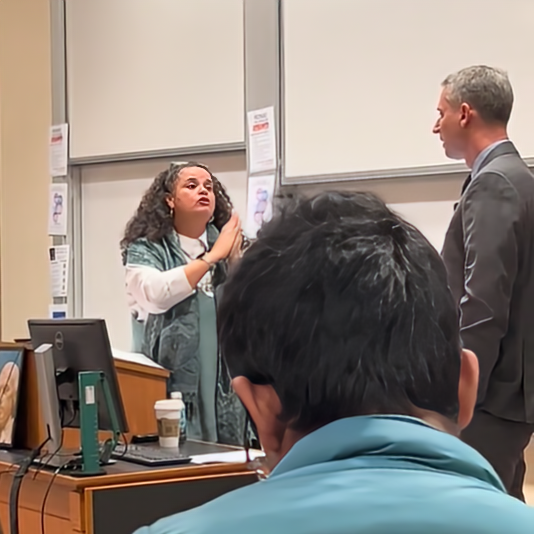 Tirien Steinbach telling invited speaker Judge Stuart Duncan that his work has harmed people in the room, so, while she firmly believes in free speech, she asks that he consider not speaking. “Is the juice worth the squeeze?” she says. “I don’t know what that means,” Judge Duncan replies. (Screenshot from footage of the Ethics and Public Policy Center)