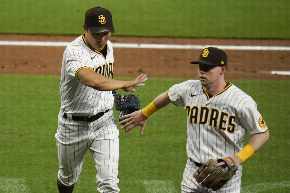 San Diego Padres shortstop Ha-Seong Kim, left, is greeted by teammate second baseman Jake Cronenworth during the second inning of a baseball game against the Pittsburgh PiratesTuesday, May 4, 2021, in San Diego. (AP Photo/Gregory Bull)