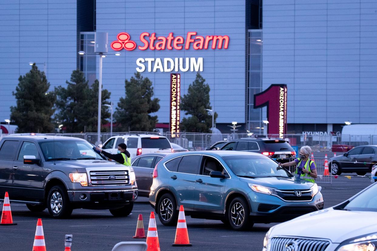 Vehicles line up at State Farm Stadium for COVID-19 vaccinations on April 6, 2021, in Glendale.