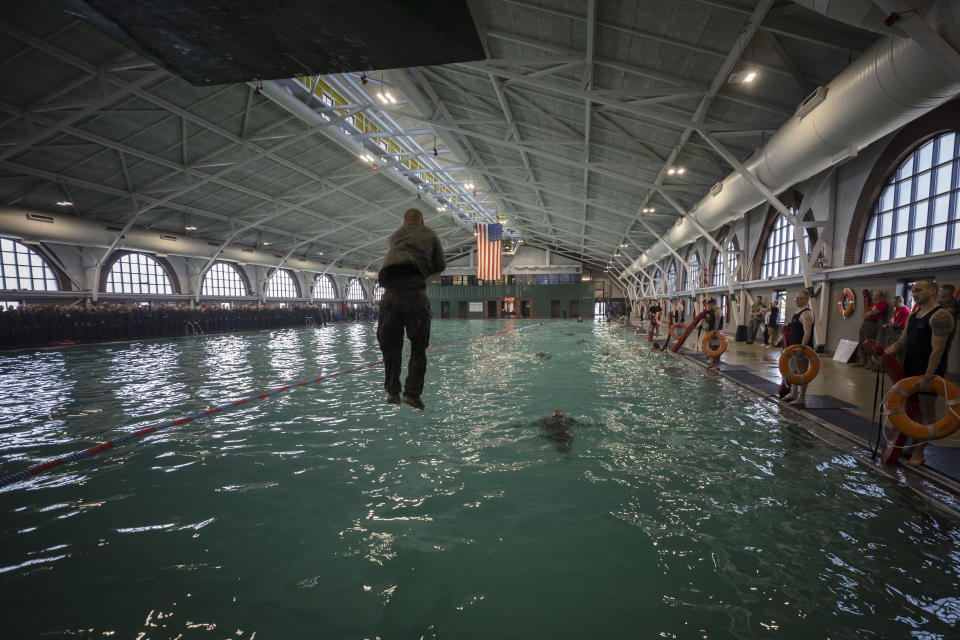 A U.S. Marine Corps recruit jumps into the water during swim training at the Marine Corps Recruit Depot pool, Wednesday, June 28, 2023, in Parris Island, S.C. (AP Photo/Stephen B. Morton)