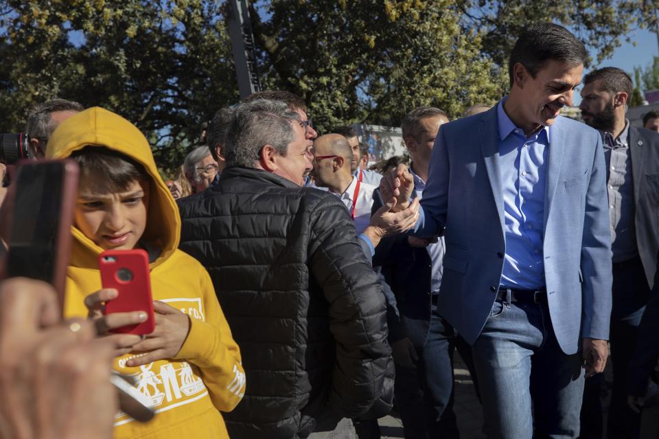 Spanish Prime Minister and Socialist Party candidate Pedro Sanchez, right, leaves a polling station after casting his vote during Spain's general election in Pozuelo de Alarcon, outskirts of Madrid, Sunday, April 28, 2019. Spain's Prime Minister Pedro Sánchez says he wants Sunday's highly contested general election to yield a parliamentary majority that can undertake social and political reforms in the country. (AP Photo/Bernat Armangue)