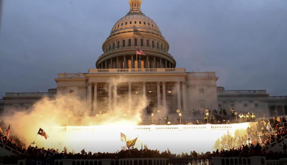 An explosion caused by a police munition is seen while supporters of U.S. President Donald Trump gather in front of the U.S. Capitol Building during the riots. Source: Reuters/Leah Millis