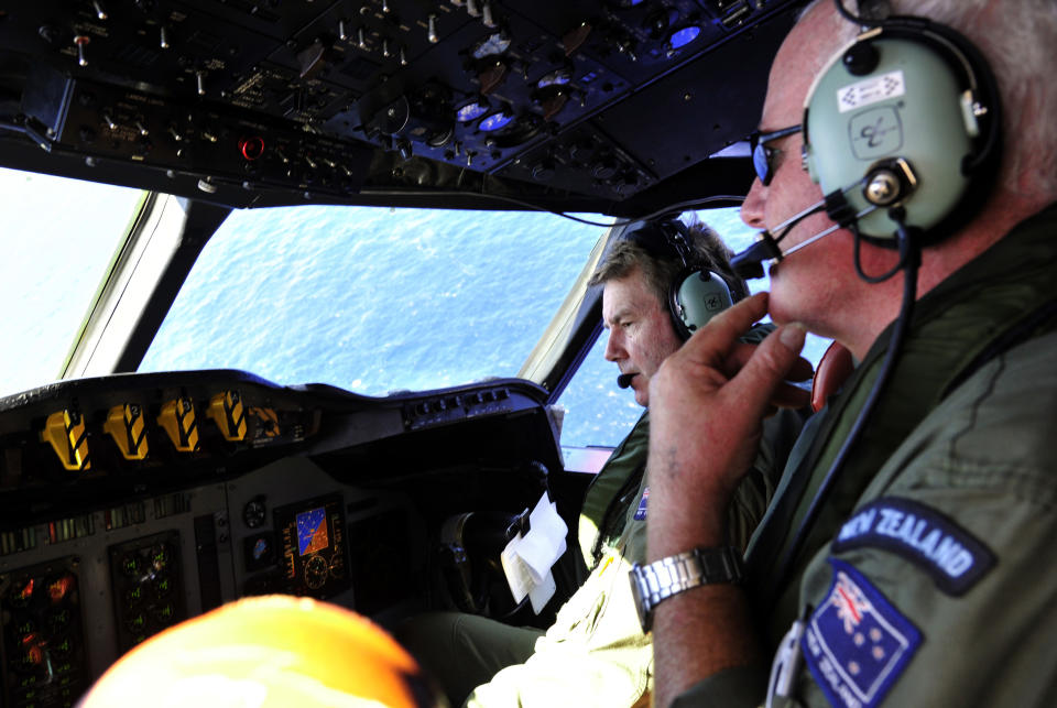 Royal New Zealand Air Force (RNZAF) co-pilot squadron leader Brett McKenzie, left, and Flight Engineer Trent Wyatt sit in the cockpit aboard a P-3 Orion on route to search over the southern Indian Ocean looking for missing Malaysia Airlines flight MH370 Friday, April 11, 2014. Authorities are confident that signals detected deep in the Indian Ocean are from the missing Malaysian jet's black boxes, Australia's Prime Minister Tony Abbott said Friday, raising hopes they are close to solving one of aviation's most perplexing mysteries. (AP Photo/Richard Polden, Pool)