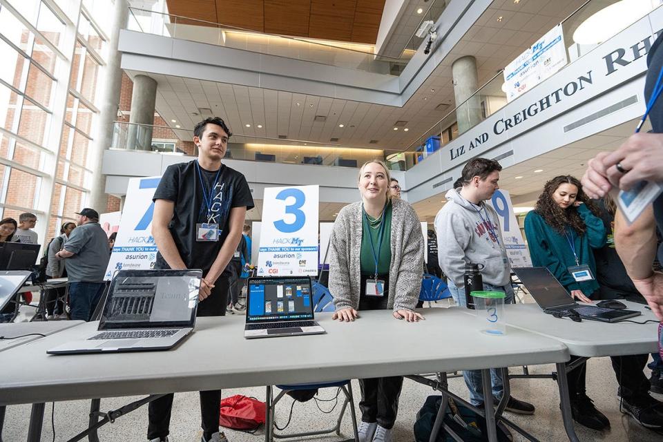 Middle Tennessee State University computer science students Whit Barrett, left, and Lorna Hedges prepare to discuss their “KOM-fused” app they helped create that would help renovate Kirksey Old Main, one of the four original buildings on the MTSU campus. The app they created was appropriately named .KOM. In all, 10 teams and a combined 80 students and industry partners participated this year in the 36-hour event from Friday, Jan. 27, through Sunday, Jan. 29, in the MTSU Science Building.