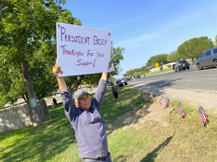 Mario and Agnes Quintanilla, center, who live directly across from the Uvalde airfield where President Biden and First Lady Jill Biden arrived and departed from Sunday, said they deeply appreciated the presidential visit during such a difficult time. (Kevin Rector / Los Angeles Times)