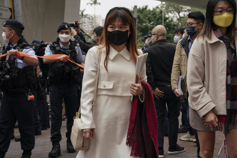 Pro-democracy activist Clarisse Yeung Suet-ying, center, arrives at the West Kowloon Magistrates' Courts to attend her national security trial in Hong Kong, Monday, Feb. 6, 2023. Some of Hong Kong's best-known pro-democracy activists went on trial Monday in the biggest prosecution yet under a law imposed by China's ruling Communist Party to crush dissent. (AP Photo/Anthony Kwan)