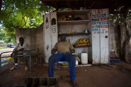 A garage owner sits in the shade in Goudiry, Senegal, September 5, 2016. REUTERS/Mikal McAllister