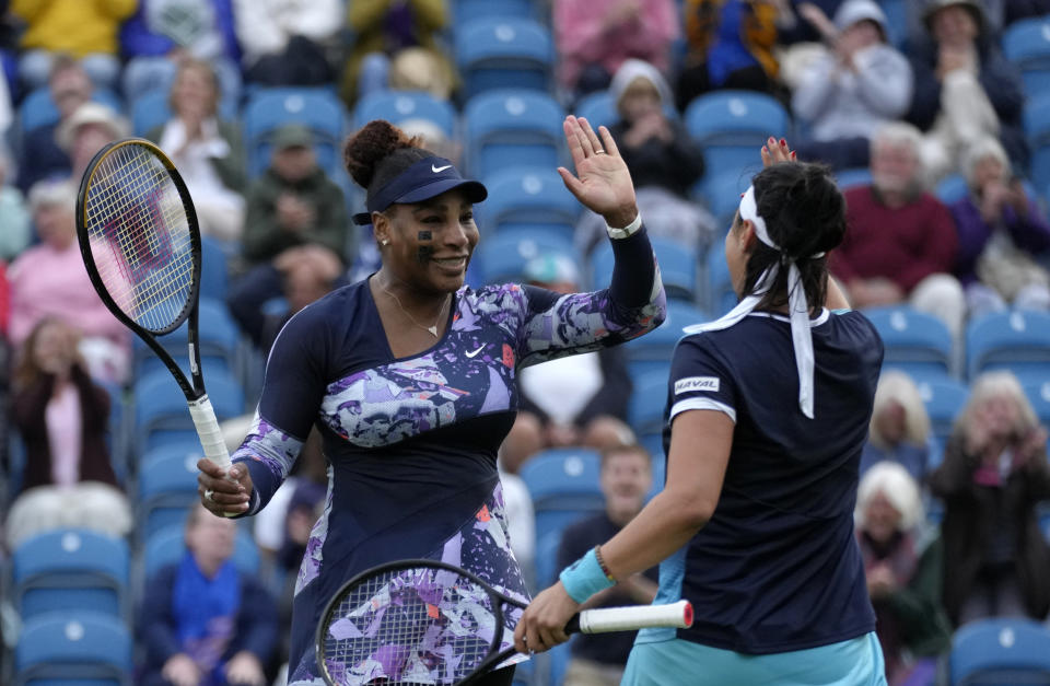 Serena Williams of the United States, left, and Ons Jabeur of Tunisia celebrate after wining their doubles tennis match against Marie Bouzkova of Czech Republic and Sara Sorribes Tormo of Spain at the Eastbourne International tennis tournament in Eastbourne, England, Tuesday, June 21, 2022. (AP Photo/Kirsty Wigglesworth)