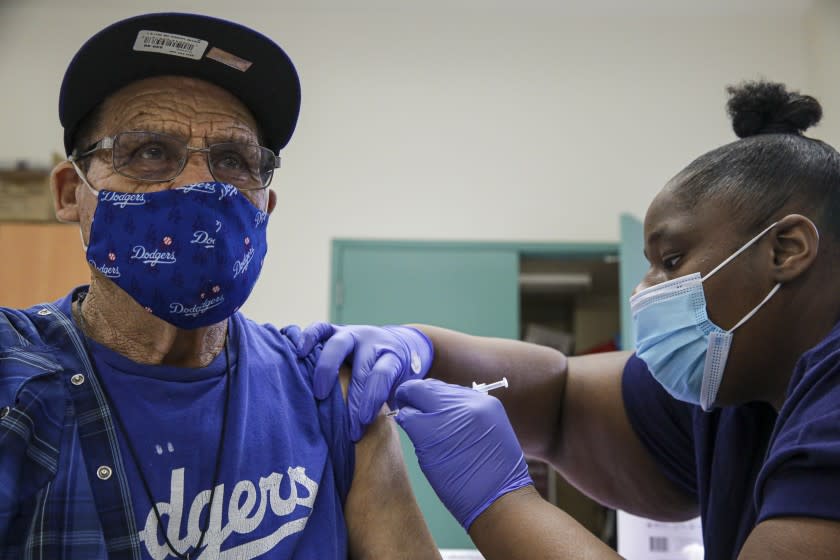 Los Angeles , CA - May 14: Jewel Morris, right, administers a Pfizer COVID-19 vaccine at mobile vaccine clinic at Roosevelt Park on Friday, May 14, 2021 in Los Angeles , CA. (Irfan Khan / Los Angeles Times)