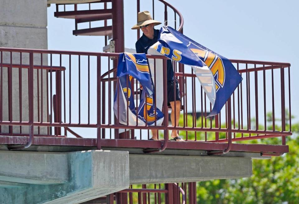 A staff member removes a banner at the end of the CIF swimming and diving state championships held at Clovis West on Saturday, May 13, 2023 in Fresno.
