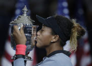 FILE - In this Sept. 8, 2018, file photo, Naomi Osaka, of Japan, kisses the trophy after defeating Naomi Osaka, of Japan, in the women's final of the U.S. Open tennis tournament in New York. Osaka is ranked No. 1 heading into the U.S. Open, where she will attempt to defend a Grand Slam title for the first time. (AP Photo/Julio Cortez, File)