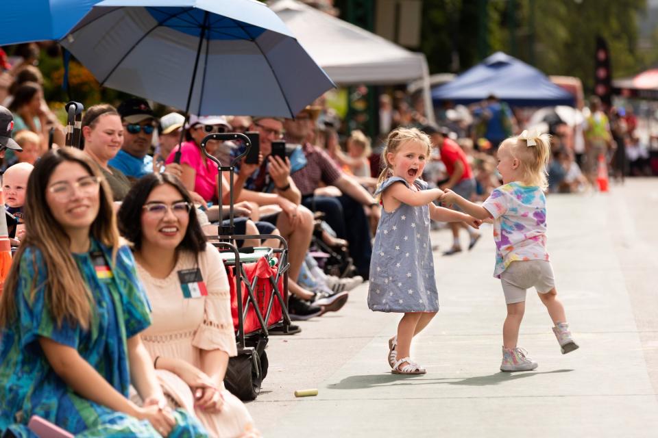 Emma Stucki, left, and Chloe Kennard dance in the streets during the annual Days of ’47 Parade in Salt Lake City on Monday, July 24, 2023. | Megan Nielsen, Deseret News