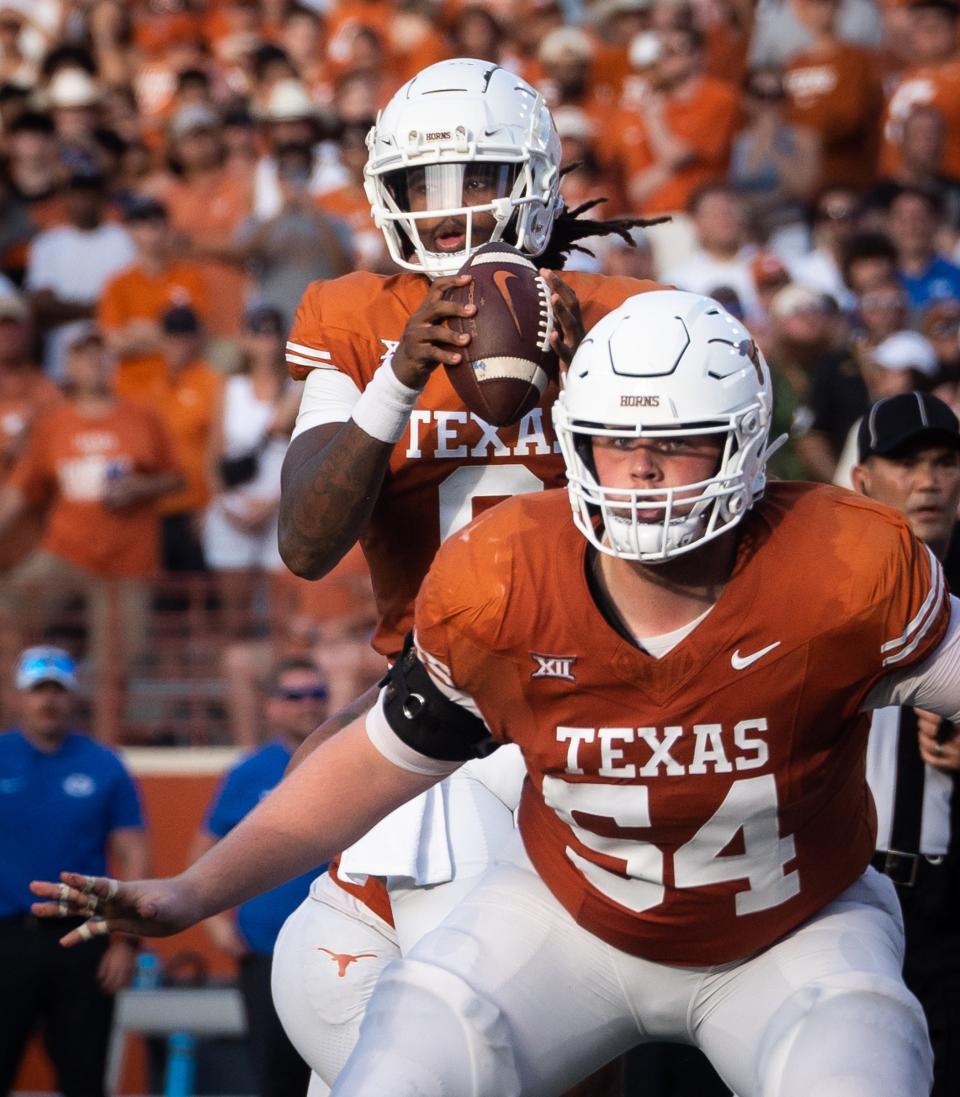 Texas quarterback Maalik Murphy takes a snap as lineman Cole Hutson protects him during the third quarter. Murphy, making his first career start, threw for 170 yards and two touchdowns but also committed two turnovers. "I feel like he had the confidence in us and we had the confidence in him as well," wide receiver Adonai Mitchell said.