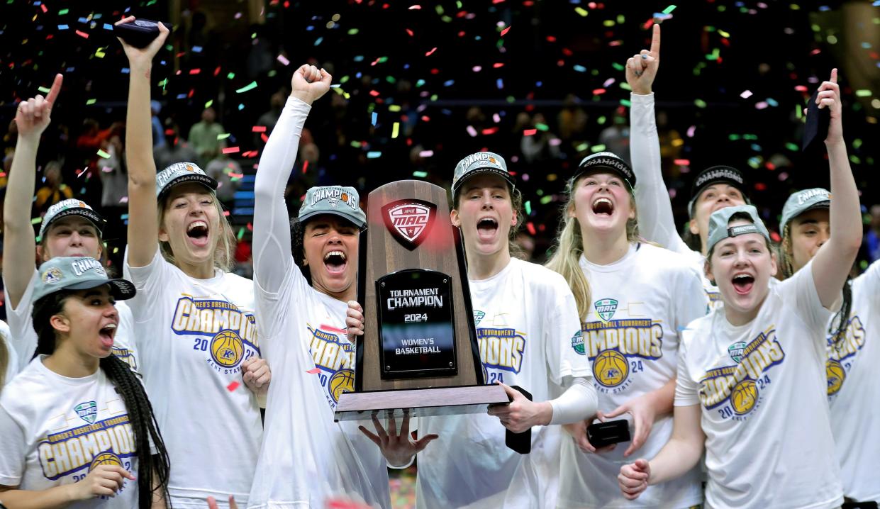 The Kent State women's basketball team celebrates winning the Mid-American Conference Tournament championship on Saturday.