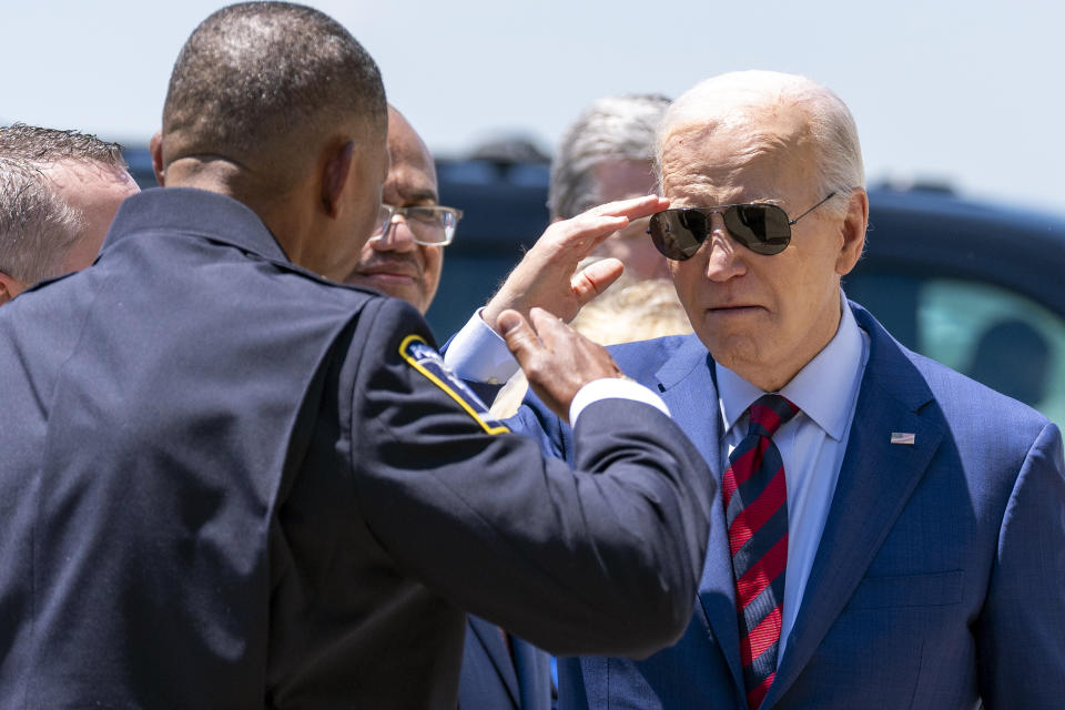 President Joe Biden salutes Charlotte-Mecklenburg Police Department Chief Johnny Jennings, as he arrives on Air Force One at Charlotte Douglas International Airport, Thursday, May 2, 2024, in Charlotte, N.C. Biden is meeting with the families of law enforcement officers shot to death on the job. (AP Photo/Alex Brandon)