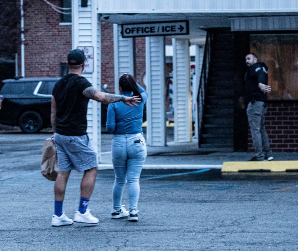 A police officer waves motel residents away from the area at the Days Inn Motel in Elmsford April 14, 2024 where a man was barricaded in a room. The situation began at around 4:00 pm and ended after 9:00 pm.