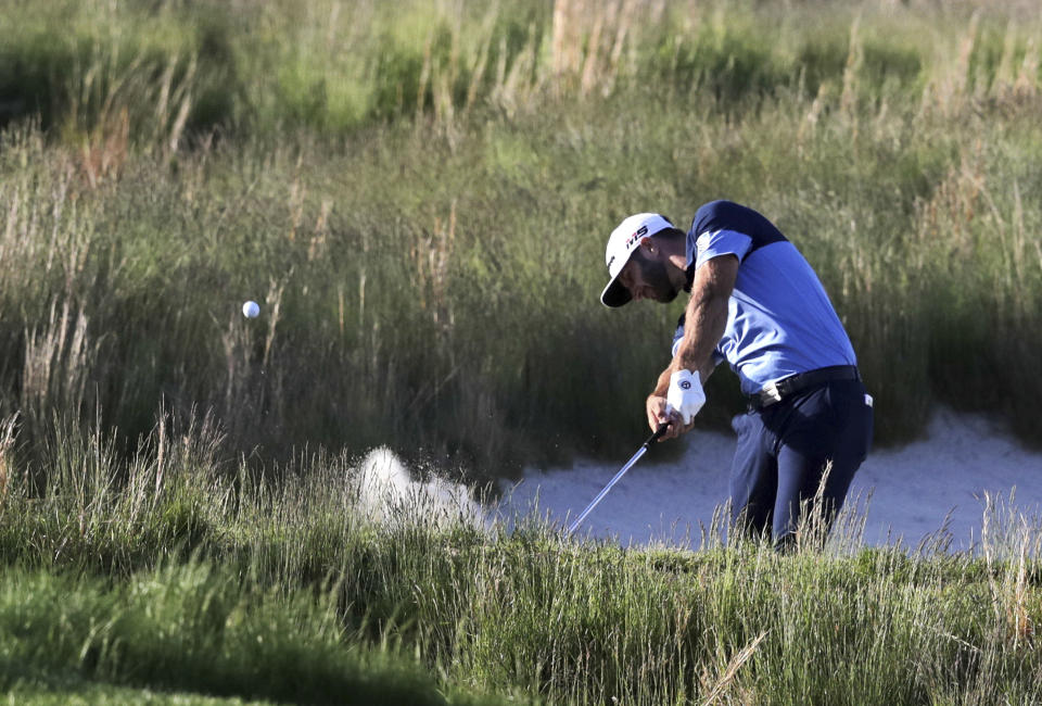 Dustin Johnson hits out of a bunker on the 18th hole during the third round of the PGA Championship golf tournament, Saturday, May 18, 2019, at Bethpage Black in Farmingdale, N.Y. (AP Photo/Charles Krupa)