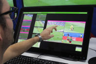 FILE - A referee demonstrates a video operation room, a facility of the Video Assistant Referee (VAR) system which will be rolled out for the first time during the World Cup, in Moscow, Russia, on June 9, 2018. VAR - the high-tech video review system formally written into the laws of soccer in 2018 to, in theory, help referees make the right calls in the biggest moments. (AP Photo/Dmitri Lovetsky, File)