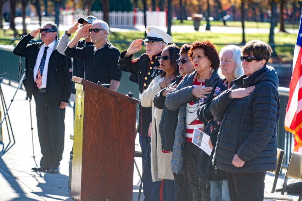 Participants salute at the Pearl Harbor Day observance at McLeod Lake Park in downtown Stockton on Wednesday, Dec. 7, 2022. 