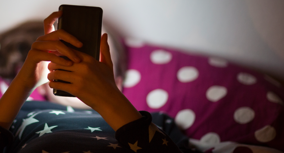 A generic image of a child on the phone, as reports of Aussie kids struggling with their mental health soar. 