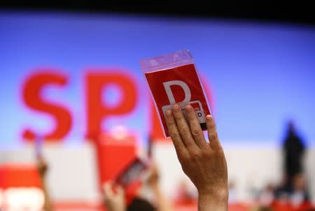 A delegate of the German Social Democratic party (SPD) votes during the party convention in Dortmund, Germany, June 25, 2017. REUTERS/Wolfgang Rattay