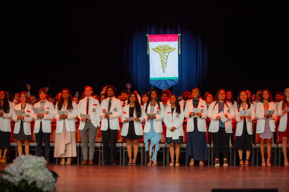 First-year medical students recite their class-composed version of the ancient Oath of Hippocrates during Friday's White Coat Ceremony held by the Texas Tech University Health Sciences Center at the Buddy Holly Hall of Performing Arts and Sciences.