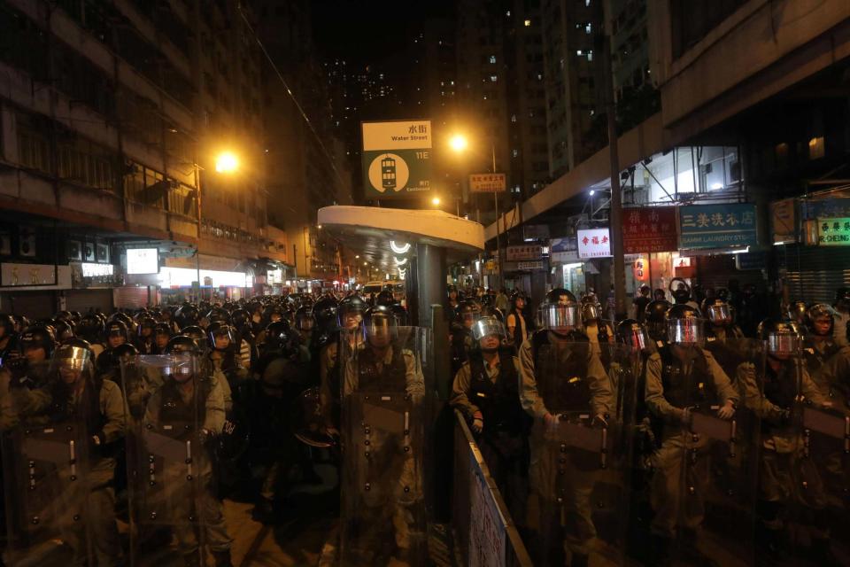 Riot police stand guard near the Chinese liaison office in Hong Kong (AFP/Getty Images)