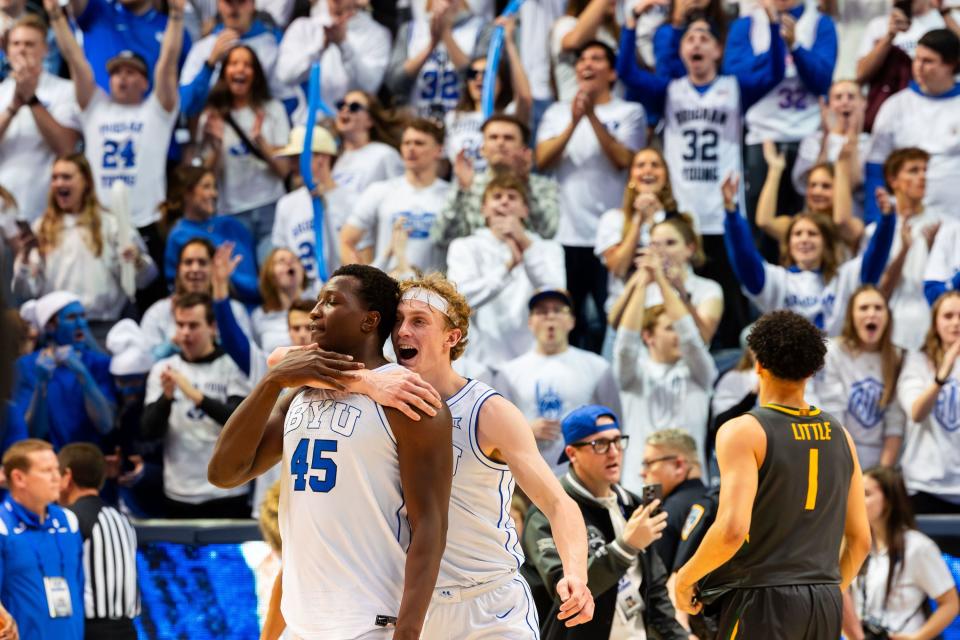 Brigham Young Cougars guard Richie Saunders (15) hugs Brigham Young Cougars forward Fousseyni Traore (45) after their victory 78-71 over Baylor University in a men’s college basketball game at the Marriott Center in Provo on Tuesday, Feb. 20, 2024. | Megan Nielsen, Deseret News