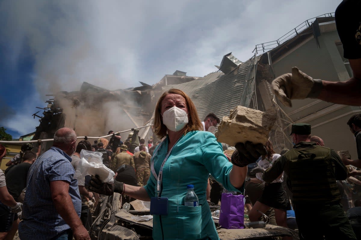 Rescue workers clear the rubble at the Ohmatdyt Children’s Hospital in Kyiv (Evgeniy Maloletka)