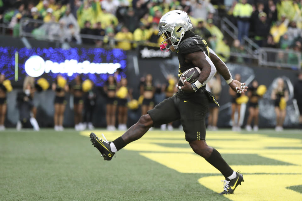 Oregon running back Bucky Irving celebrates after scoring a touchdown against California during the second half of an NCAA football game, Saturday, Nov. 4, 2023, in Eugene, Ore. (AP Photo/Amanda Loman)