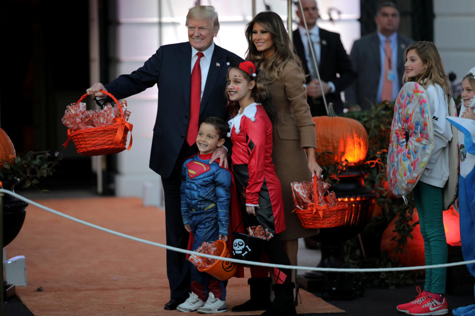 <p>U.S. President Donald Trump and First Lady Melania Trump pose for a picture as they give out Halloween treats to children from the South Portico of the White House in Washington, D.C. on Oct. 30, 2017. (Photo: Carlos Barria/Reuters) </p>