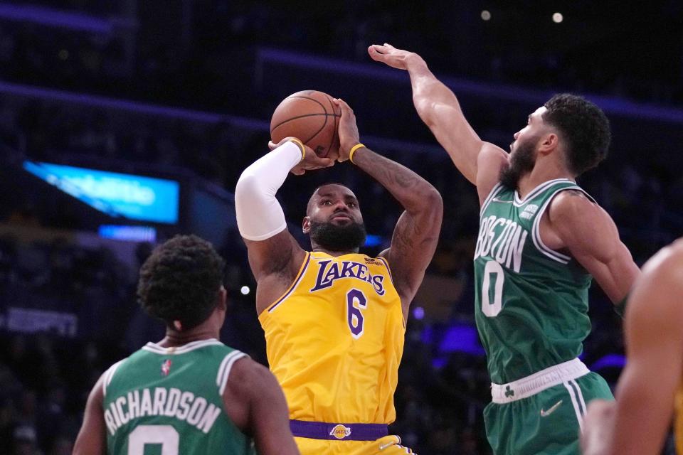 Dec 7, 2021; Los Angeles, California, USA; Los Angeles Lakers forward LeBron James (6) is defended by Boston Celtics forward Jayson Tatum (0) in the first half at Staples Center. Mandatory Credit: Kirby Lee-USA TODAY Sports