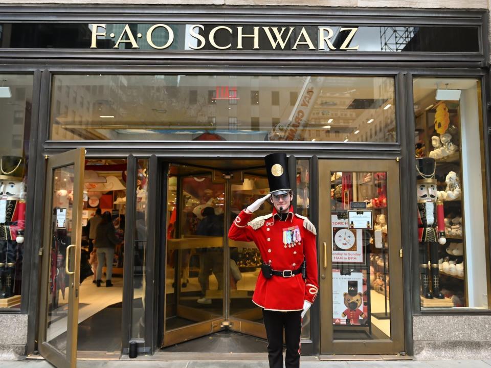 A doorman stands outside FAO Schwarz in Rockefeller Center on November 15, 2021.