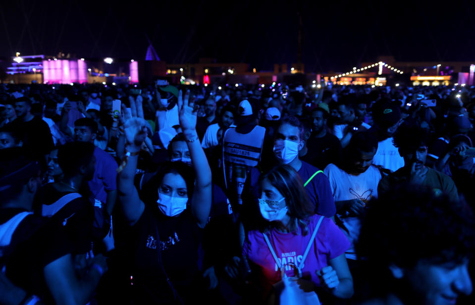 Fans of Canadian pop star Justin Bieber dance as he performs at a concert marking the end of Formula One, in Jiddah, Saudi Arabia, Sunday, Dec. 5, 2021. (AP Photo/Amr Nabil)