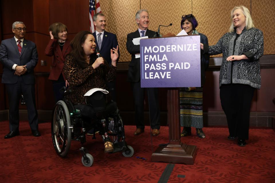 Sen. Tammy Duckworth, center, and fellow congressional Democrats discuss modernizing the Family and Medical Leave Act and establishing paid leave on Feb. 1, 2023.
