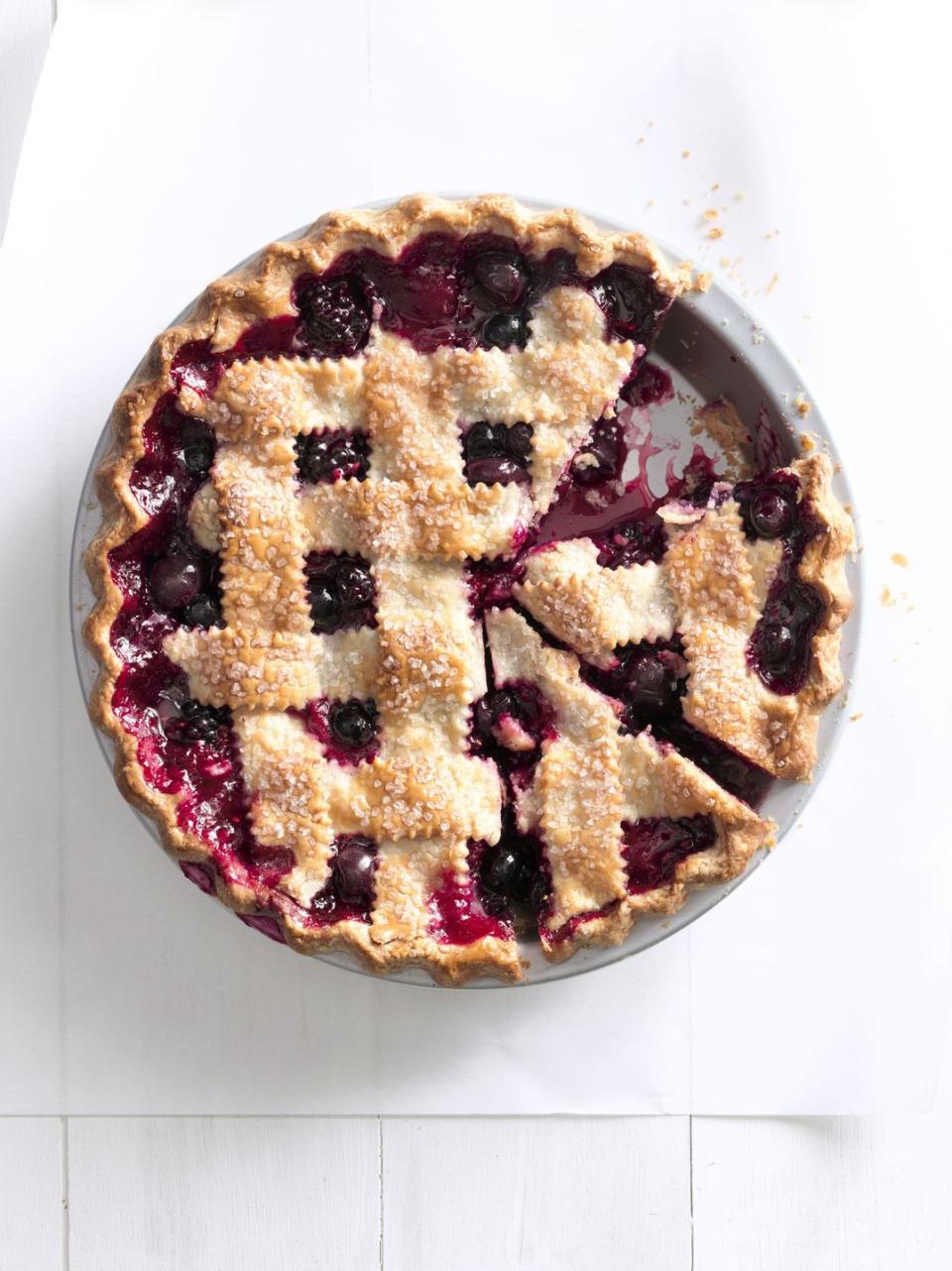 cherry berry jumble fruit pie with a lattice pie crust in a metal pie dish