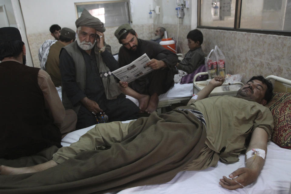 People visit their family member who survived a bombing, at a hospital in Quetta, Pakistan, Thursday, July 26, 2018. The suicide attack outside the polling station in Quetta which killed dozens of people, underscored the difficulties the majority Muslim nation faces on its wobbly journey toward sustained democracy. (AP Photo/Arshad Butt)