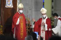 Stephen Chow, left, attends the episcopal ordination ceremony as the new Bishop of the Catholic Diocese, in Hong Kong, Saturday, Dec. 4, 2021. The new head of Hong Kong's Catholic diocese expressed hope Saturday that he could foster healing in a congregation and a city divided by the continuing fallout from massive anti-government protests in 2019. (AP Photo/Kin Cheung)