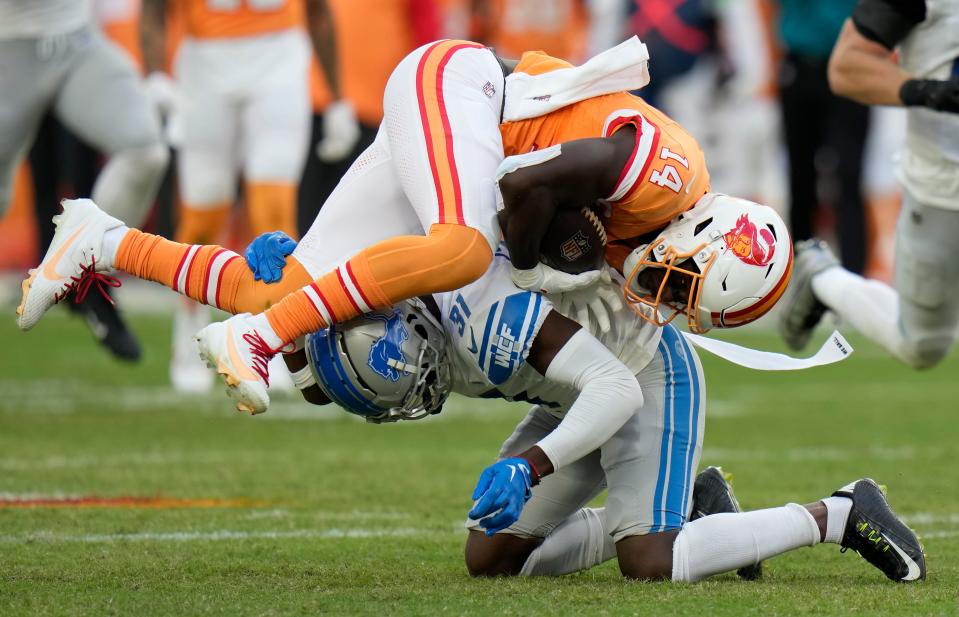 Tampa Bay Buccaneers wide receiver Chris Godwin (14) is stopped by Detroit Lions safety Kerby Joseph (31) during the second half of an NFL football game Sunday, Oct. 15, 2023, in Tampa, Fla. (AP Photo/Chris O'Meara)