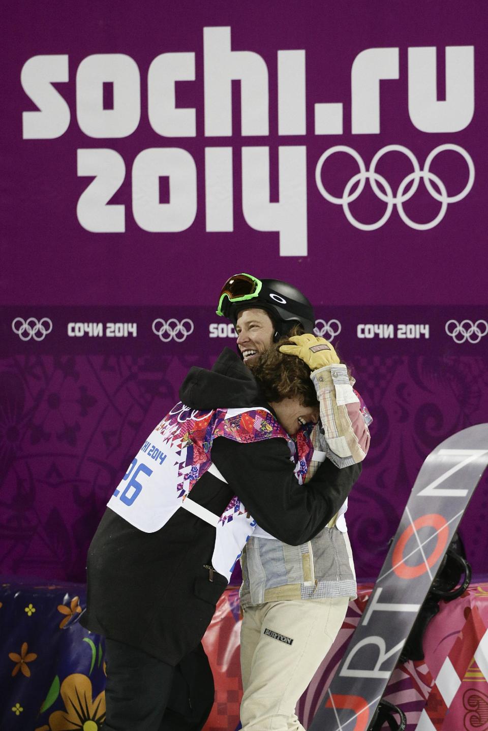 Switzerland's Iouri Podladtchikov, left, celebrates with Shaun White, of the United States, after Podladtchikov won the gold medal in the men's snowboard halfpipe final at the Rosa Khutor Extreme Park, at the 2014 Winter Olympics, Tuesday, Feb. 11, 2014, in Krasnaya Polyana, Russia. (AP Photo/Jae C. Hong)