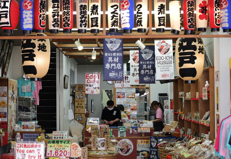 Employees work at a shop in Tsukiji Outer Market in Tokyo