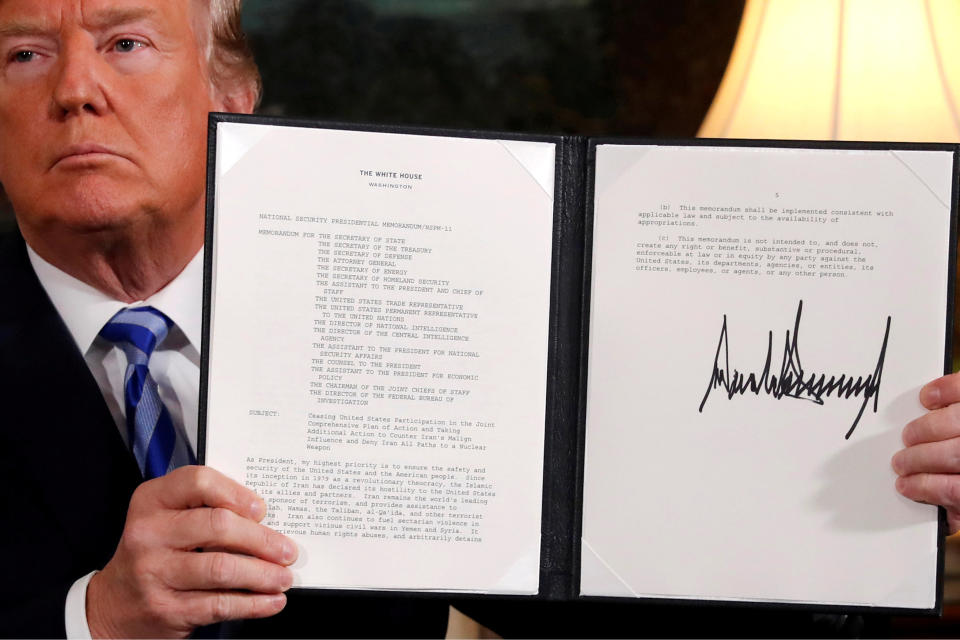 U.S. President Donald Trump holds up a proclamation declaring his intention to withdraw from the JCPOA Iran nuclear agreement. REUTERS/Jonathan Ernst/File Photo