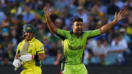 Pakistan bowler Sohail Khan makes an appeal for LBW that dismissed Australia's batsman Aaron Finch (L) during their Cricket World Cup quarter final match in Adelaide, March 20, 2015. REUTERS/David Gray