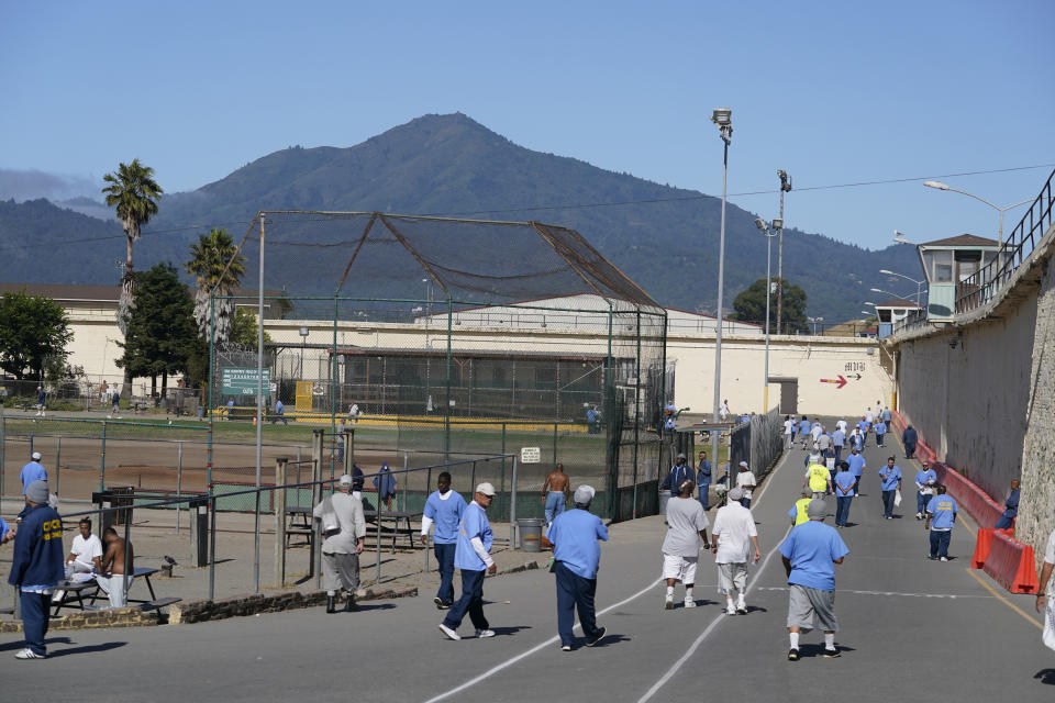 Incarcerated men are seen in the recreation yard with Mt. Tamalpais in the background during a media tour at San Quentin State Prison in San Quentin, Calif., on July 26, 2023. California Gov. Gavin Newsom has ambitious and expensive plans for a dilapidated factory at San Quentin State Prison where inmates of one of the nation's most notorious lockups once built furniture. He wants to spend $360 million demolishing the building and replacing it with one more reminiscent of a college campus, with a student union, classrooms and possibly a coffee shop. (AP Photo/Eric Risberg)