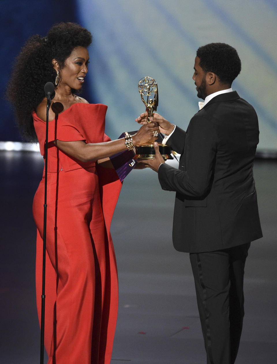 Angela Bassett , left, presents Jharrel Jerome with the award for outstanding lead actor in a limited series or movie for "When They See Us"at the 71st Primetime Emmy Awards on Sunday, Sept. 22, 2019, at the Microsoft Theater in Los Angeles. (Photo by Chris Pizzello/Invision/AP)